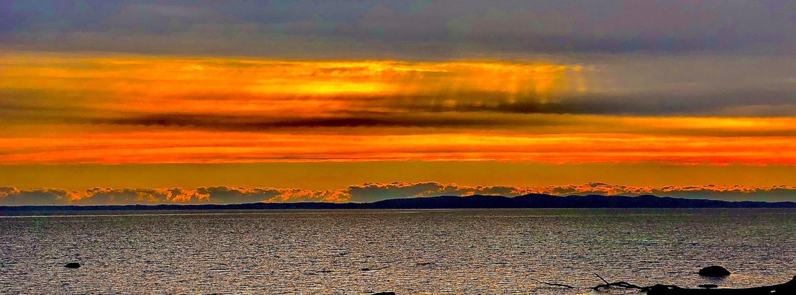Sunrise over calm water